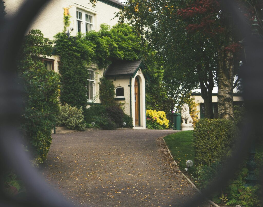 A house with bushes and trees in the background