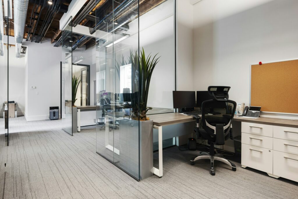 A room with glass walls and a desk.