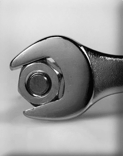 Here's an alt tag for the image: `Wrench tightening a nut`