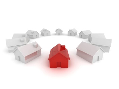 Red house surrounded by white houses.